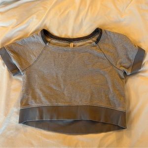 Lucy cropped tshirt/sweater. Never worn! Size medium.
